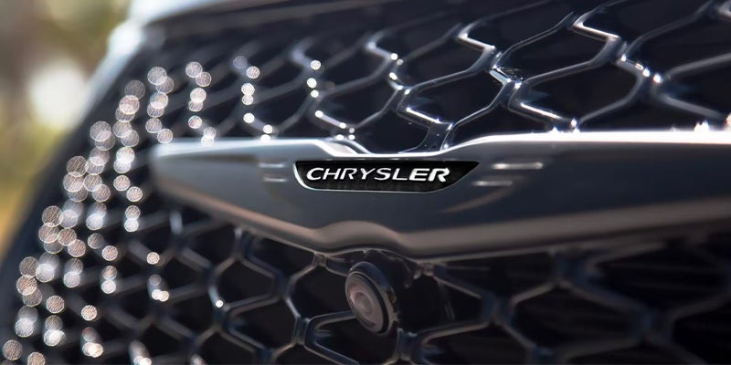 Chrysler logo on car grille with front camera
