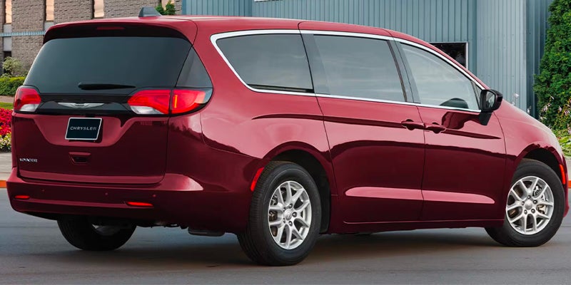 Red Chrysler Pacifica minivan rear side view