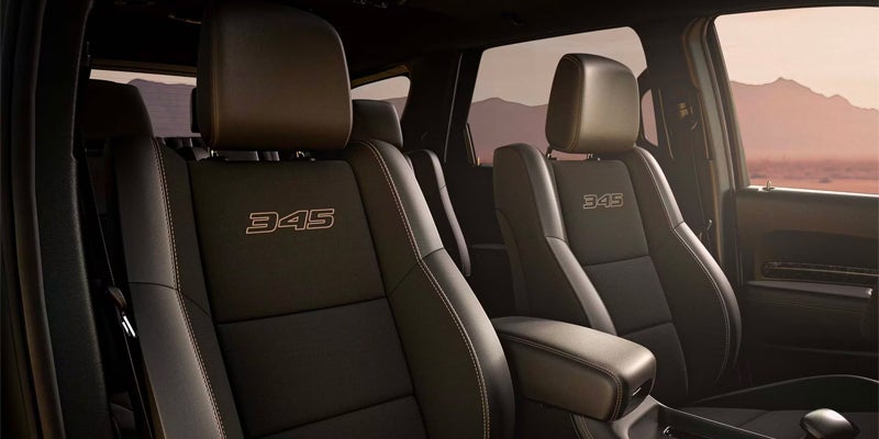 Interior shot of black leather seats with "345" embroidered on them