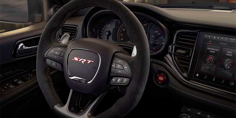 Driver's view of a Dodge SRT steering wheel and digital instrument cluster
