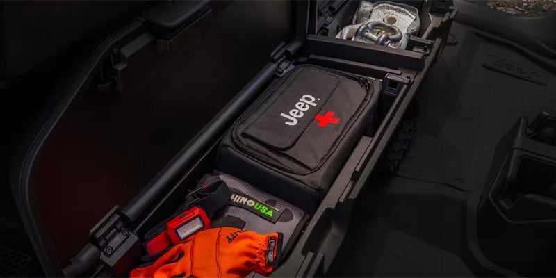 Under-seat storage compartment in a Jeep with a first aid kit