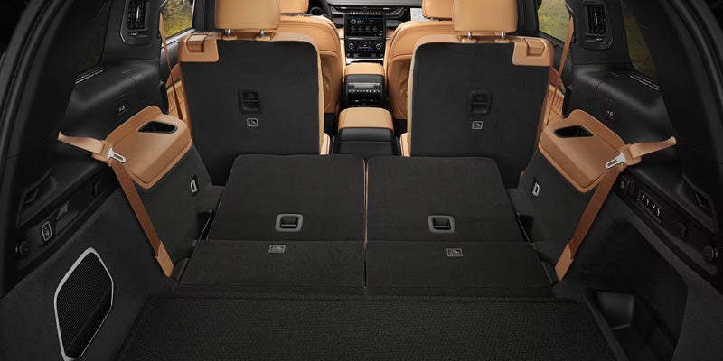 View from the rear of an SUV, with the back two rows of seats folded flat to maximize cargo space.