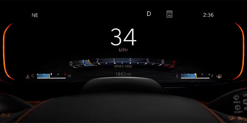 A black digital display shows "34 MPH," RPM, fuel, temperature, 1963 miles, speed limit 45, and 2:36.