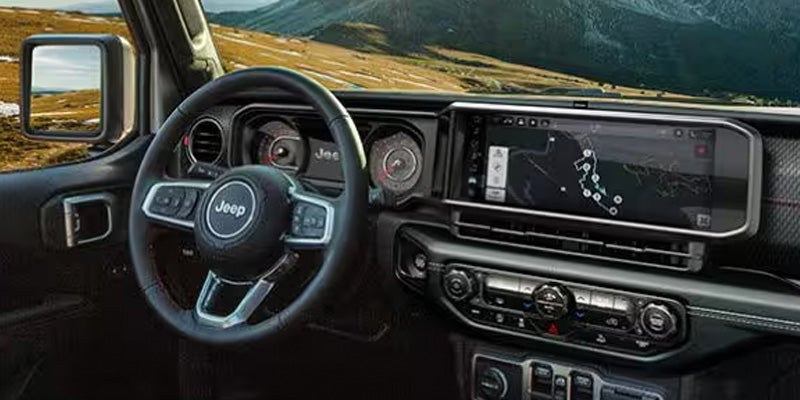 Interior view of a Jeep steering wheel and dashboard